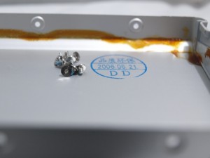 Torx screws removed and date of manufacture under the cover removed from the MacBook battery.